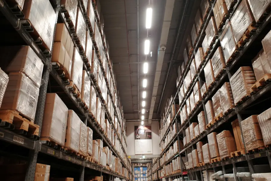 Warehouse aisles with boxed goods stacked on pallet racks